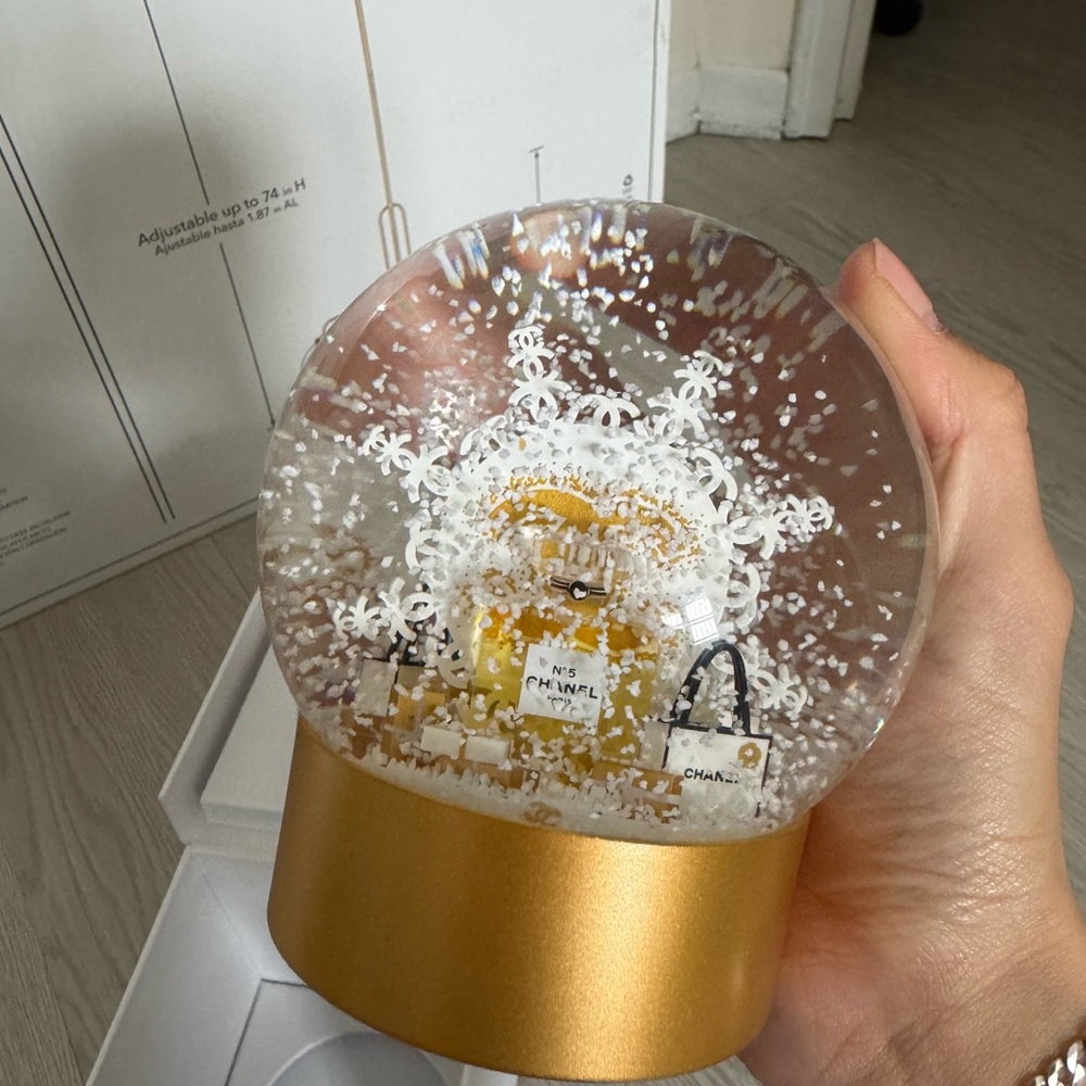 CHANEL Gold Base Snow Globe with White Snowflakes and Yellow Bottle